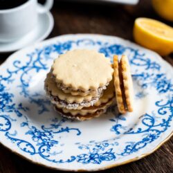 These Alfajores cookies are soft and chewy with a tangy lemon flavor on the outside and packed with creamy dulce de leche on the inside!