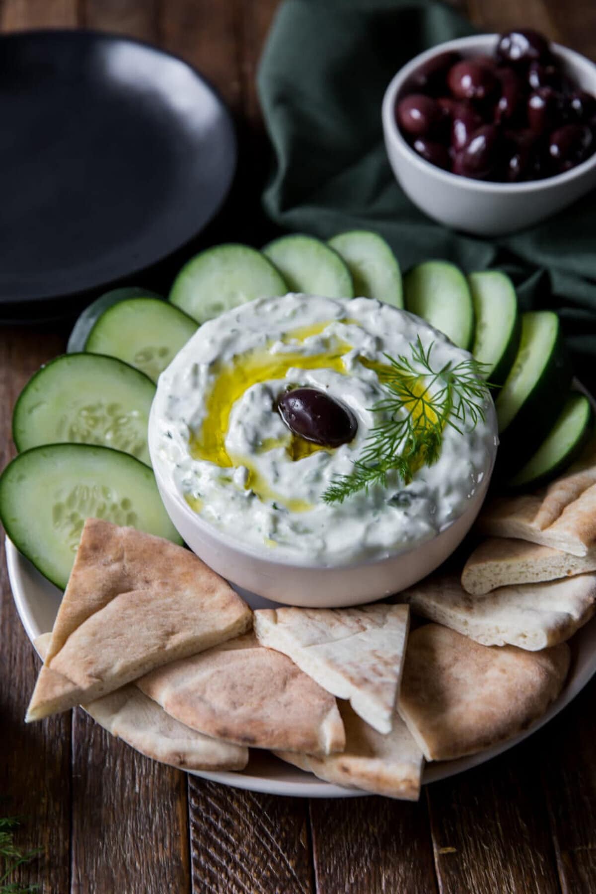Tzatziki in a bowl with dippers around.