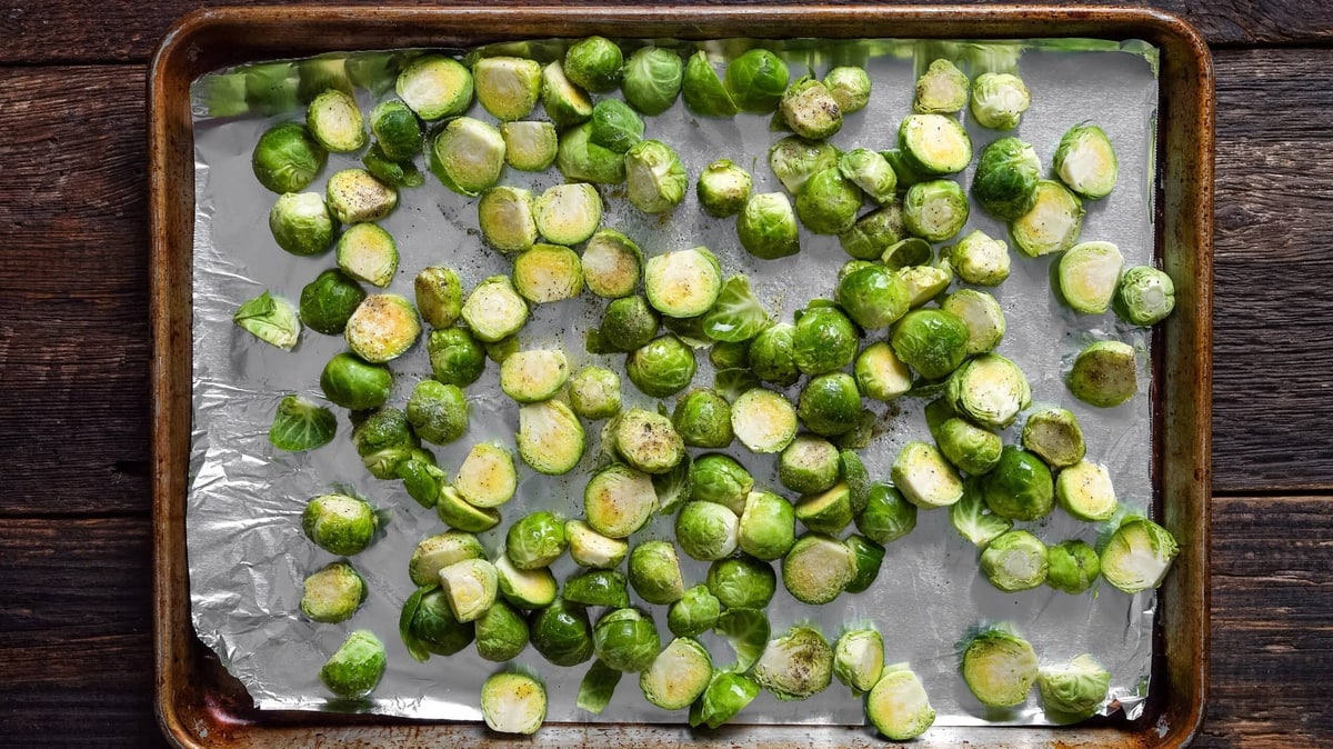 Brussels sprouts on a baking pan before cooking.