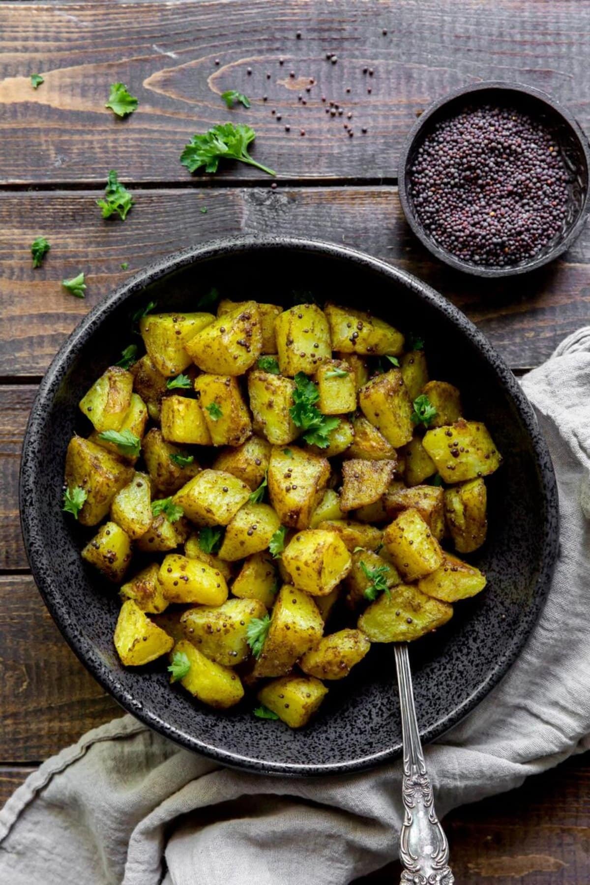 Indian Bombay Potatoes in a black bowl