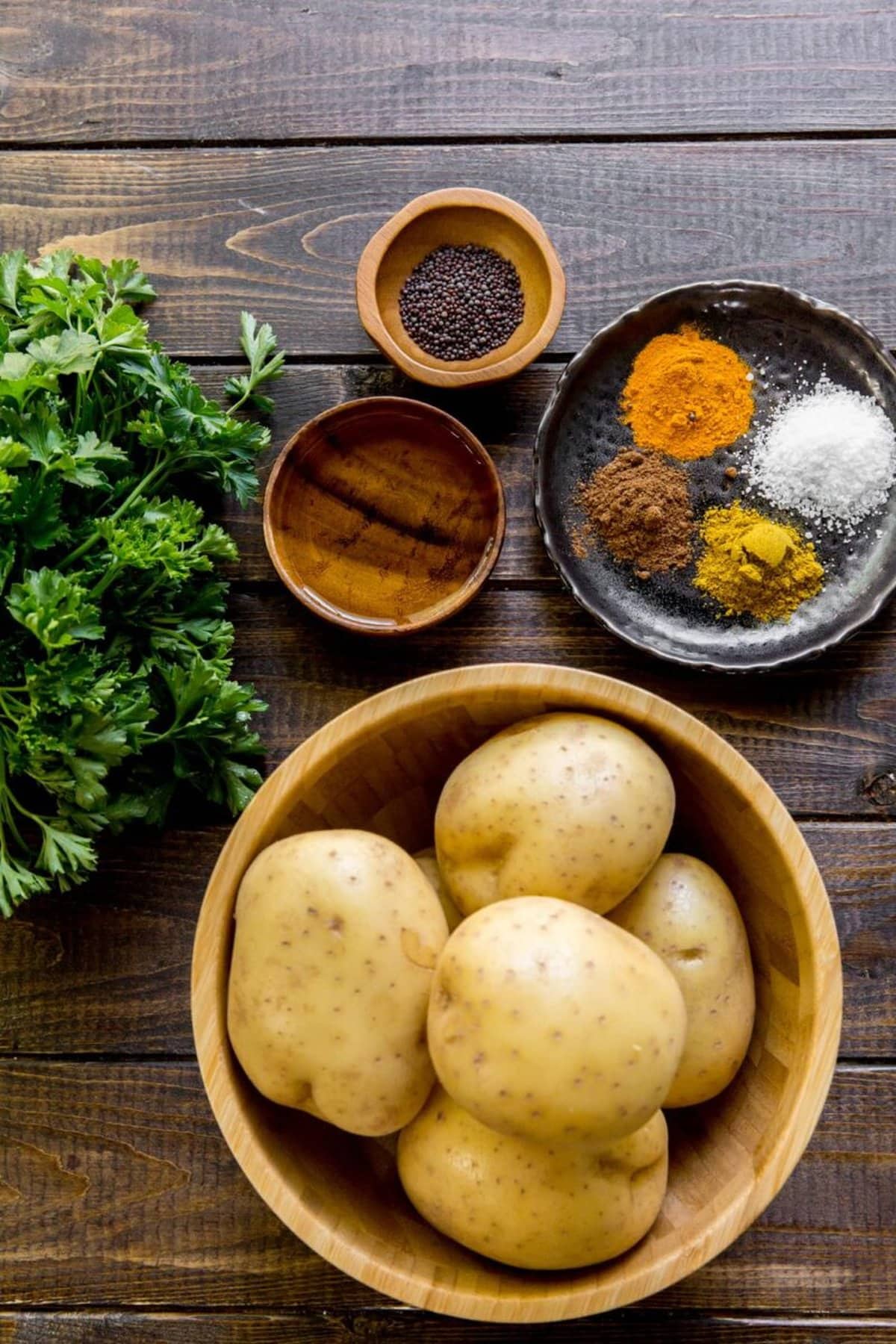 Indian Bombay Potatoes recipe ingredients in bowls on a table
