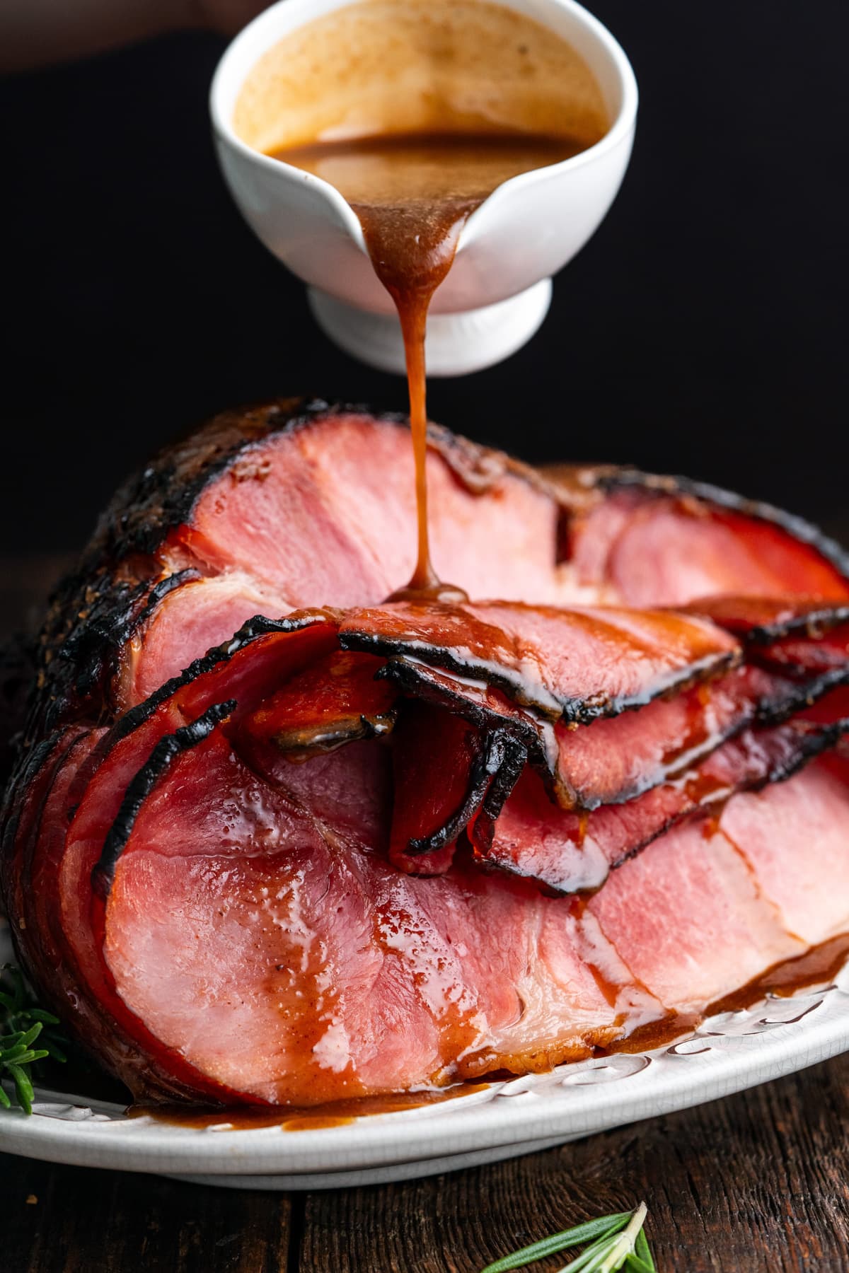 Glaze being poured over a baked ham.