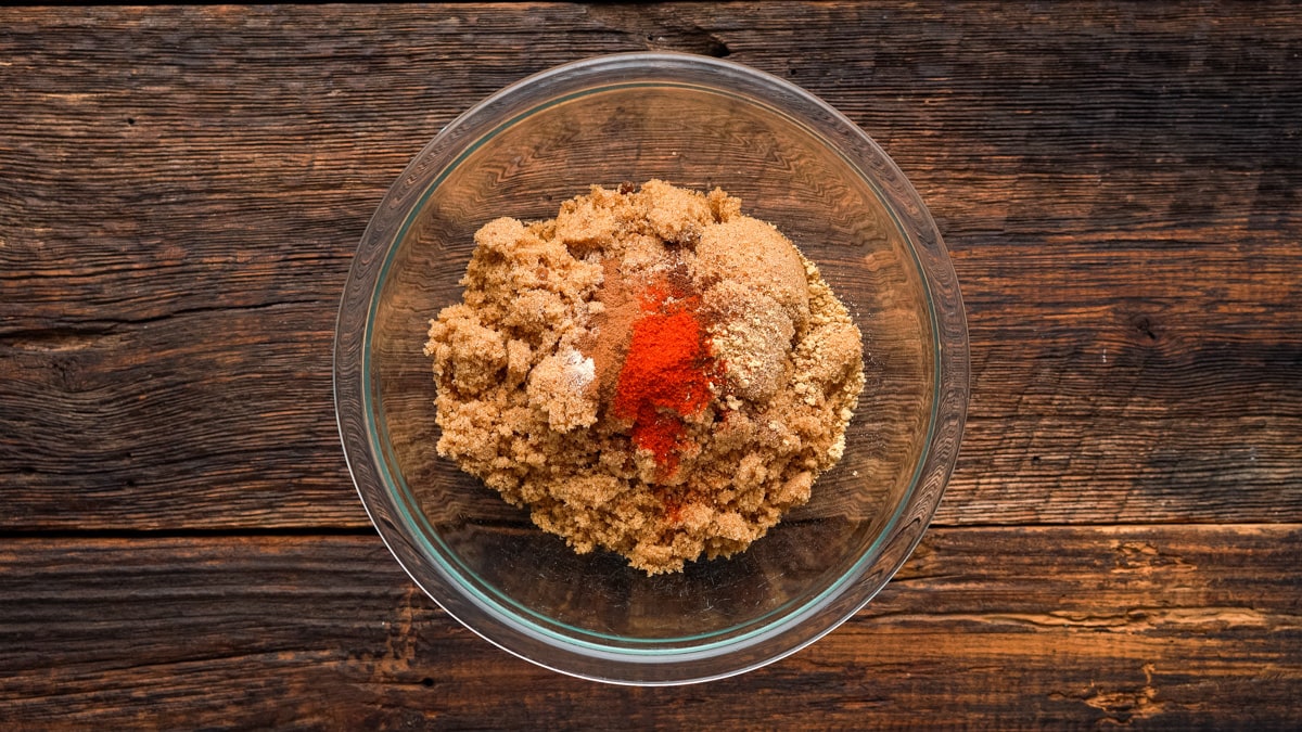 Brown sugar and spices in a glass bowl before mixing.