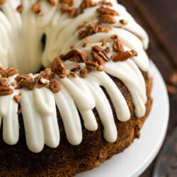 This Carrot Bundt Cake is a delightful and moist dessert made with grated carrots, crunchy pecans, warm spices, and a sweet frosting on top!