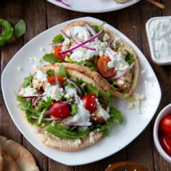 This Greek Chicken Souvlaki recipe is made with a delicious lemon, garlic and spice marinade and so tasty when loaded onto a pita bread with your favorite toppings, like lettuce, tomatoes, onion, tzatziki sauce and feta cheese!