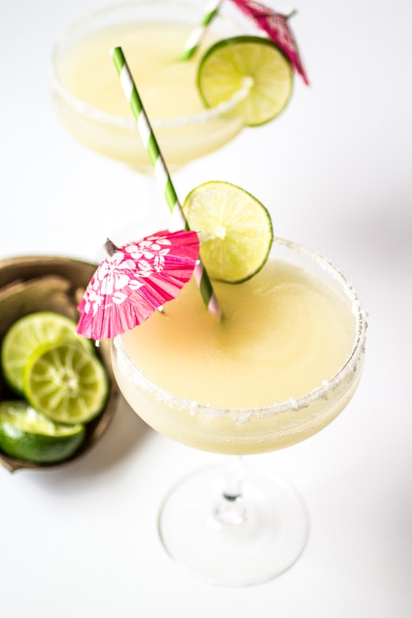 This "from-scratch" frozen coconut margaritas recipe uses lime juice and agave nectar in place of syrupy pre-made mix. Blended with coconut tequila and served with a coconut-salt rim, these tropical drinks will whisk you away to paradise!