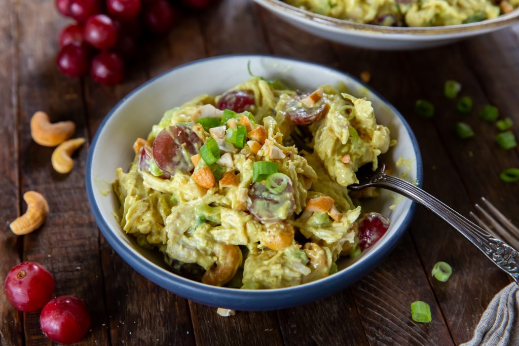 Looking for curry chicken salads? Here is a great recipe! This Curry Chicken Salad recipe is a delicious blend of chicken, savory curry powder, sweet grapes, scallions, celery and cashews for a side dish, snack or a great sandwich.