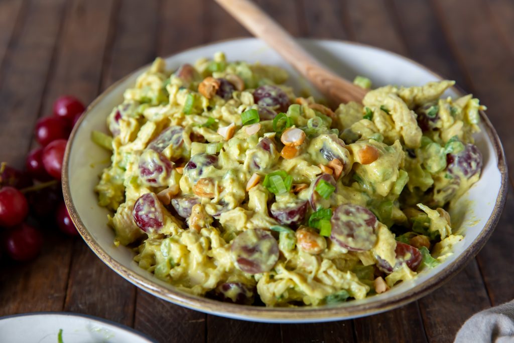 This Curried Chicken Salad recipe is a delicious blend of chicken, savory curry powder, sweet grapes, scallions, celery and cashews for a side dish, snack or a great sandwich.