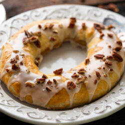 This Danish Kringle recipe is filled with traditional remonce filling alongside an array of chopped nuts and topped with a sweet and silky glaze to make a classic Danish pastry!