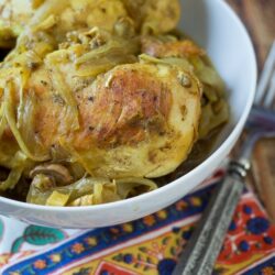 This East African Braised Chicken recipe is loaded with rich spices and flavors, and cooked with lots of broth and onion to keep the chicken tender.