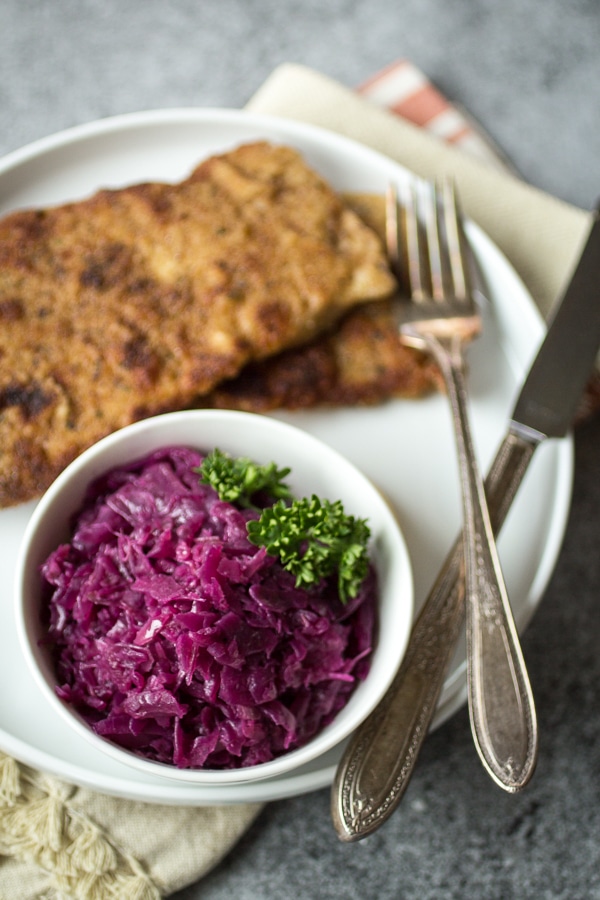 Juniper berries, green apple, and tangy vinegar give this German red cabbage it's distinctive sweet and sour flavor. Make a big batch of this "rotkohl" and watch it disappear!