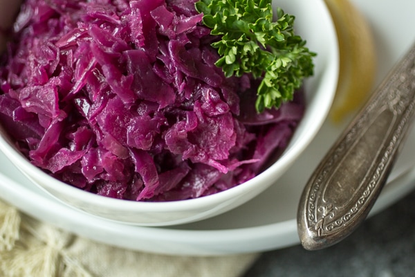 Juniper berries, green apple, and tangy vinegar give this German braised red cabbage it's distinctive sweet and sour flavor. Make a big batch of this "rotkohl" and watch it disappear!