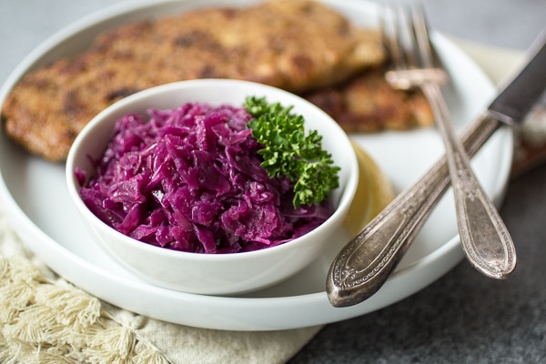 Juniper berries, green apple, and tangy vinegar give this German cabbage it's distinctive sweet and sour flavor. Make a big batch of this "rotkohl" and watch it disappear!