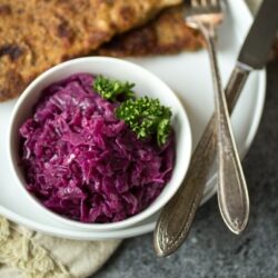 Juniper berries, green apple, and tangy vinegar give this German braised red cabbage it's distinctive sweet and sour flavor. Make a big batch of this "rotkohl" and watch it disappear!