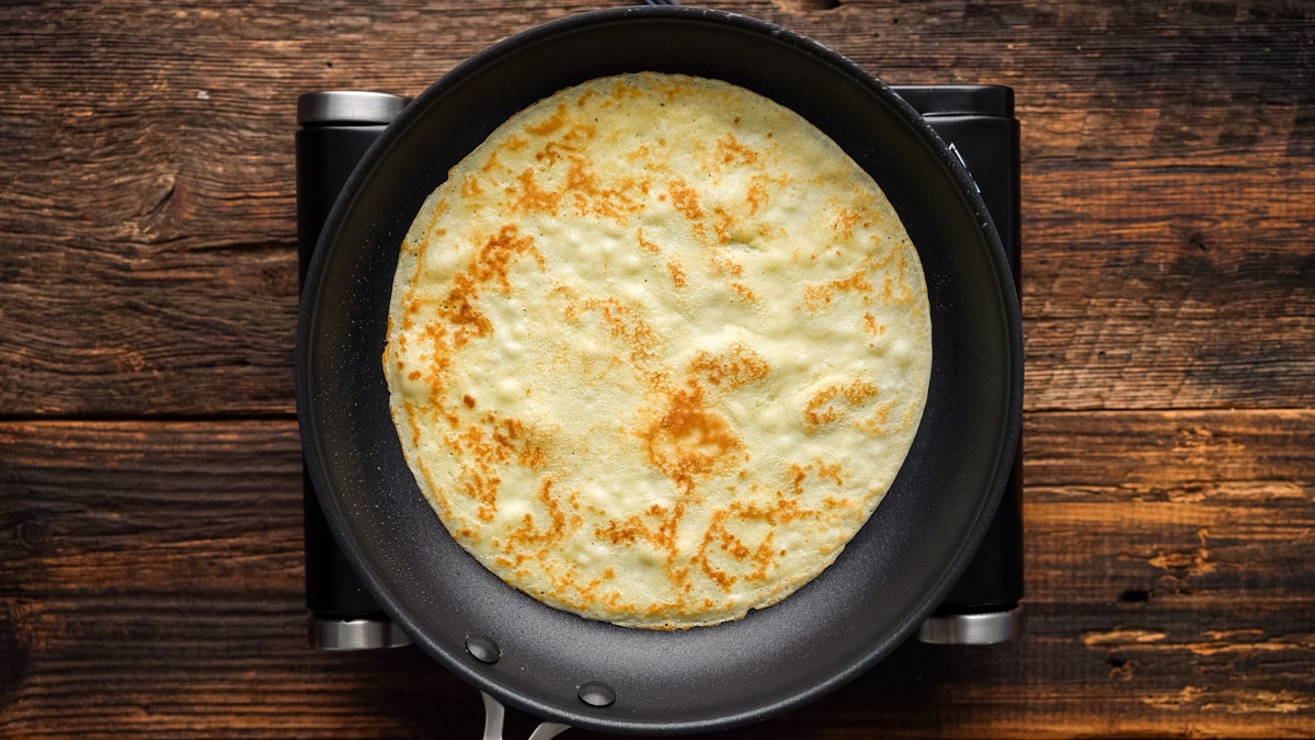 Crepes being cooked in a pan
