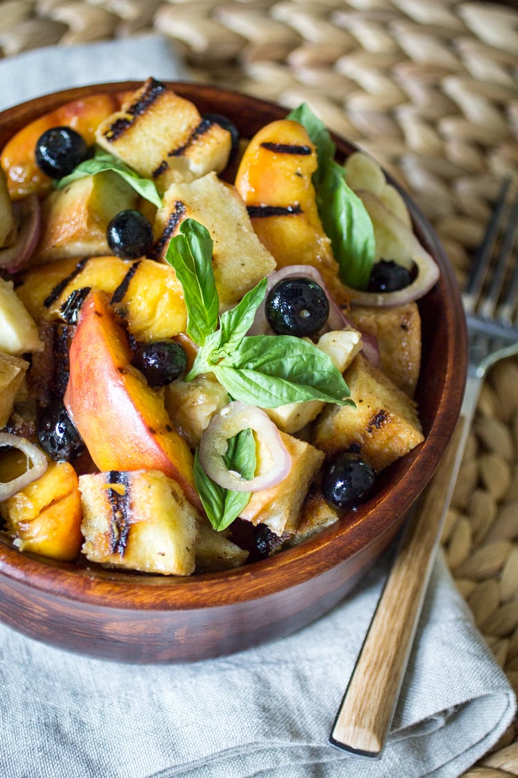 This Grilled Panzanella Salad recipe makes the perfect summer salad - blueberries, basil, ripe peaches and bread make this a delectable treat!