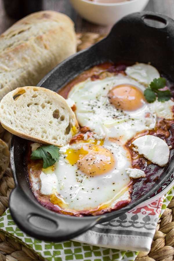 This Harissa Shakshuka recipe is a classic dish of eggs simmered in spicy tomato sauce that will both delight and satisfy. Be sure to serve your Harissa Shakshuka (or, eggs in purgatory) with plenty of crusty bread for dipping! 