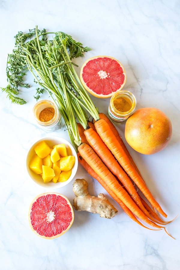 This immunity juice recipe blends grapefruit, mango, and carrot for a delicious, healthy drink that is perfect for those days when you feel like you're coming down with something!