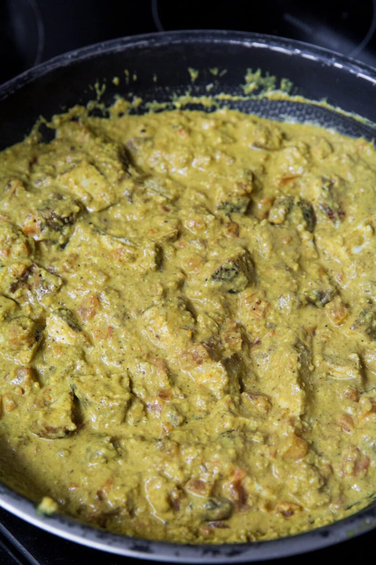 Chicken korma sauce and chicken all mixed together in the skillet.