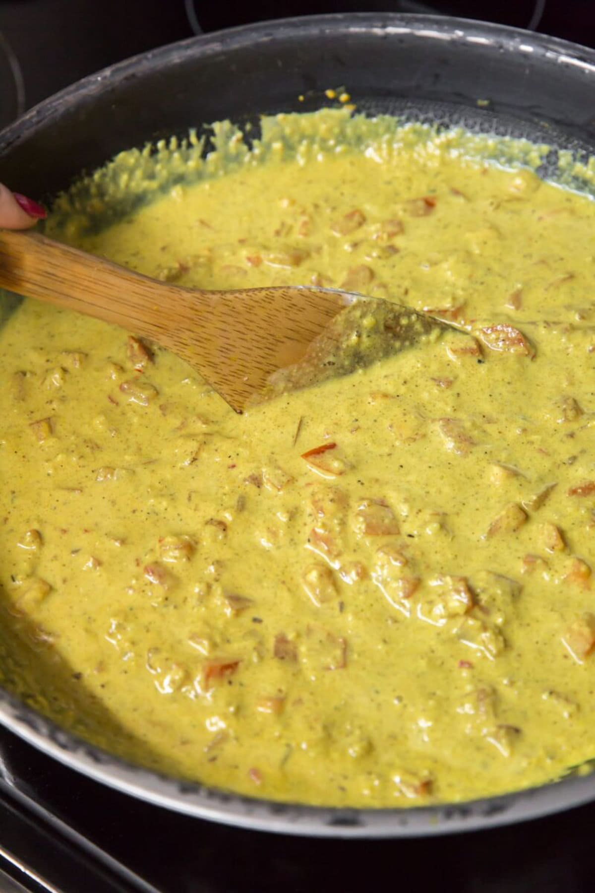 Korma sauce simmering in a pan.