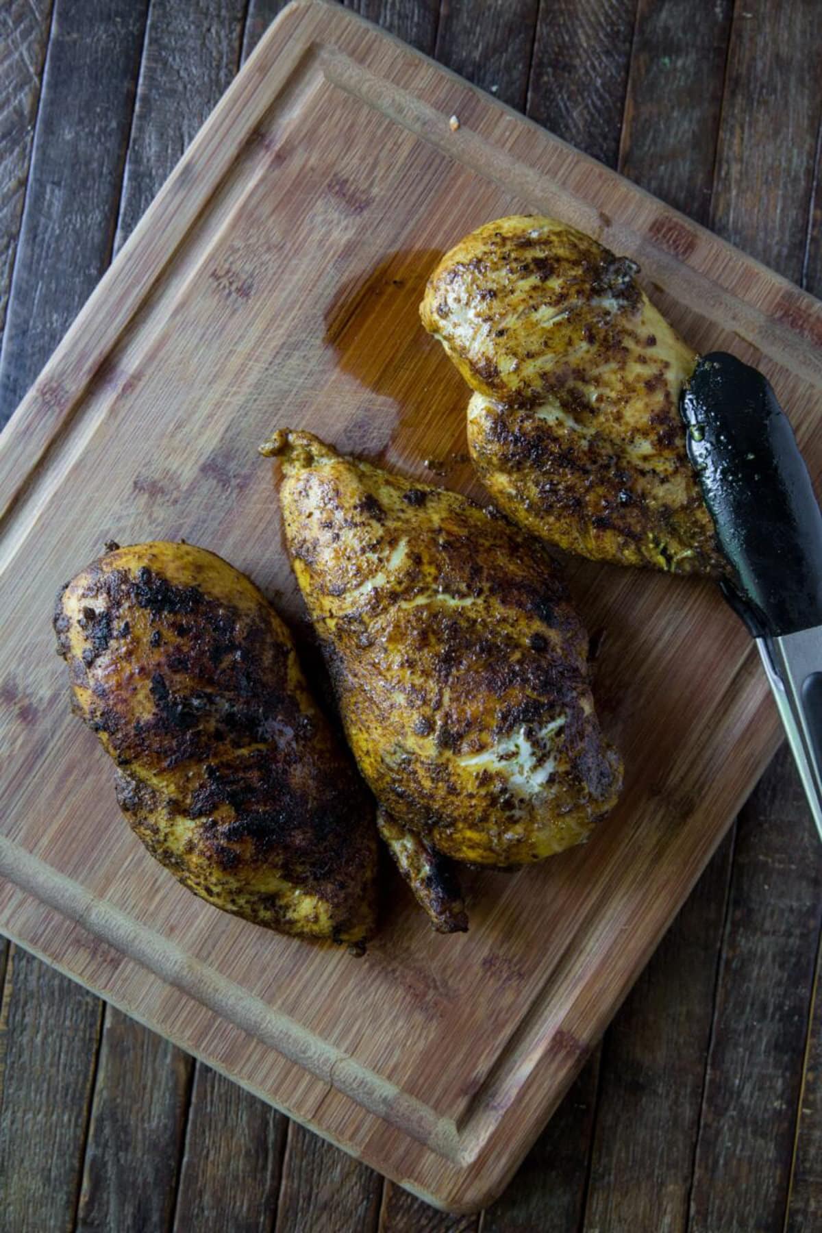 Chicken resting on a cutting board.