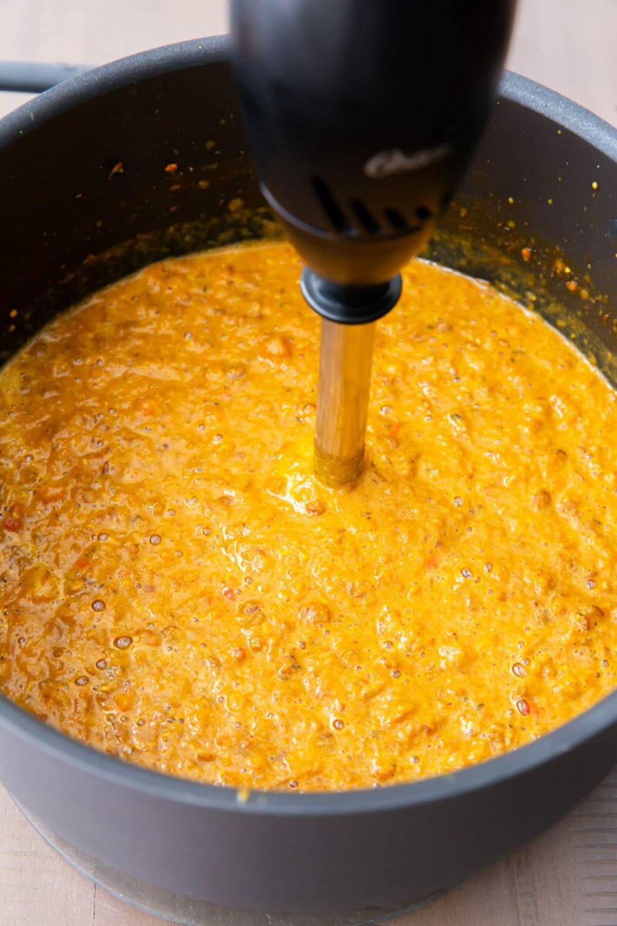 Immersion blender in the pot of  Mulligatawny Soup to puree it.