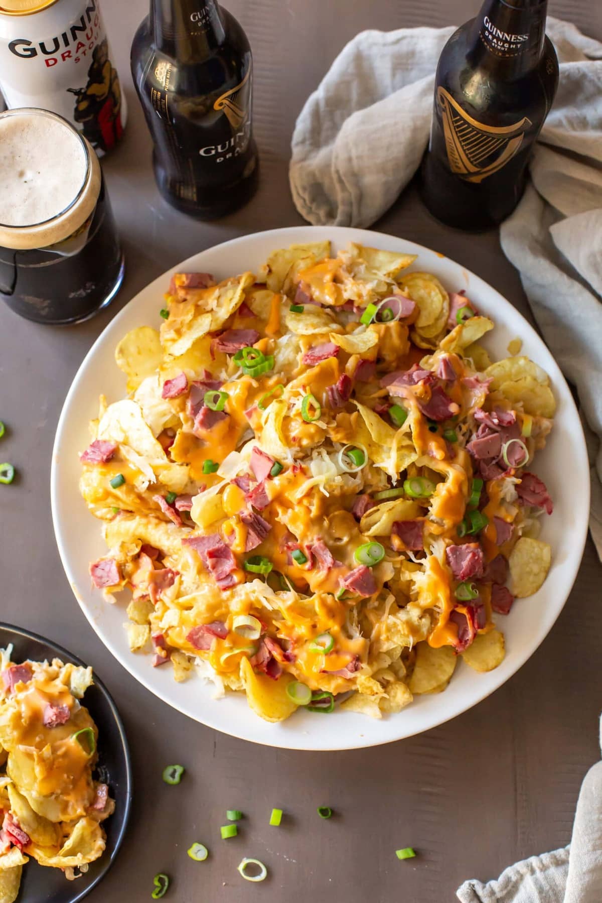 Irish Nachos covered in cheese, sauerkraut, corned beef, and beer cheese sauce, served with Guinness beer.