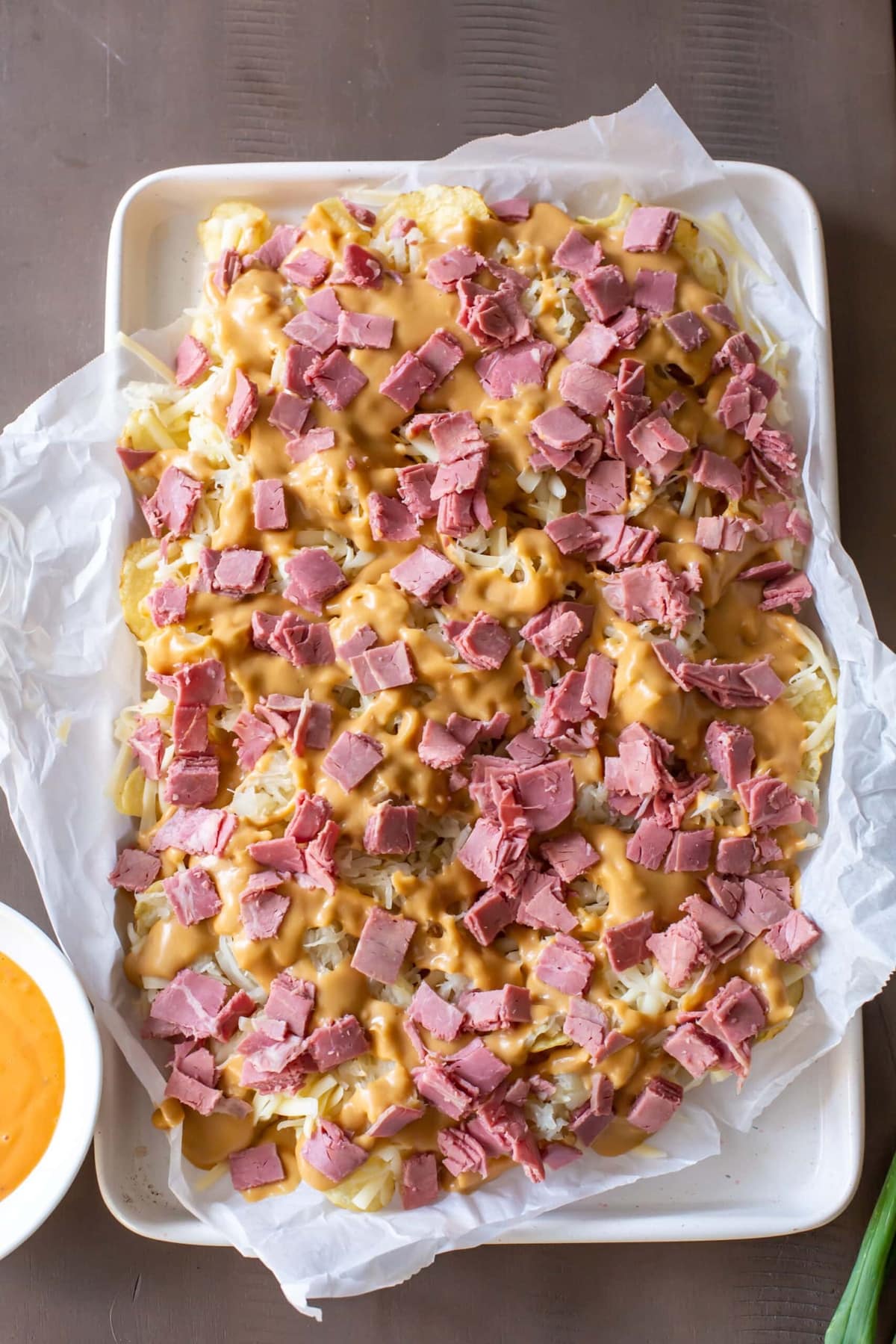 Cheesy nachos topped with corned beef.