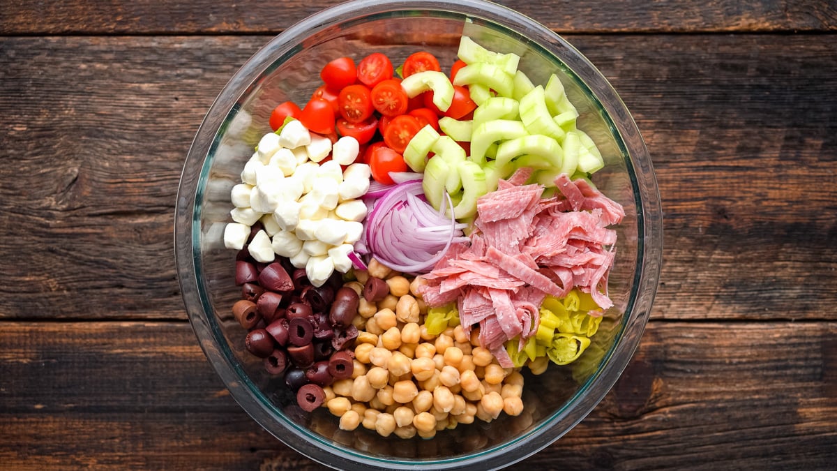 Italian Chopped Salad ingredients in a glass bowl.