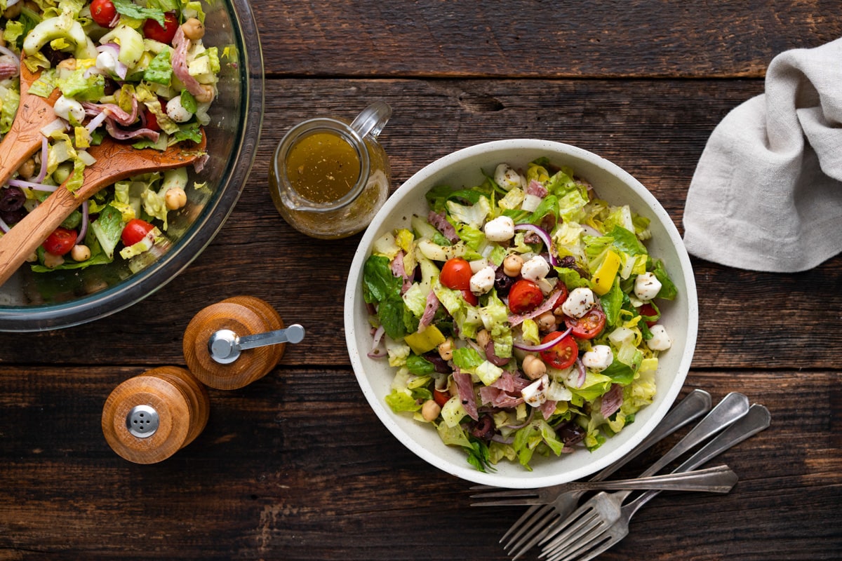 Overhead view of a prepared Italian Chopped Salad in a white bowl.