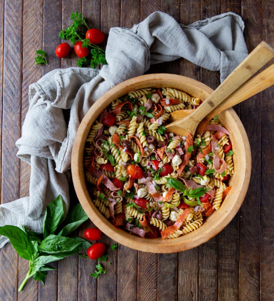 This easy Italian Pasta Salad Recipe is a burst of color filled with salami, pepperoncini, Kalamata olives, mozzarella and so much more!
