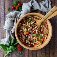 This Italian Pasta Salad Recipe is a burst of color filled with salami, pepperoncini, Kalamata olives, mozzarella and so much more!