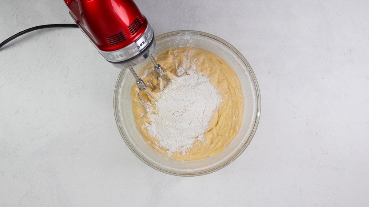 adding the flour into the batter and mixing it in