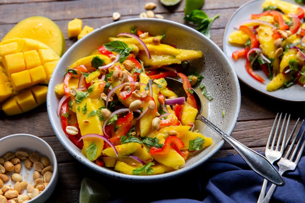 Looking for salads with mango? Check this out.  This Mango Salad recipe has sweet mangoes, crisp bell peppers and onions, and a tangy lime dressing that all pairs together perfectly!