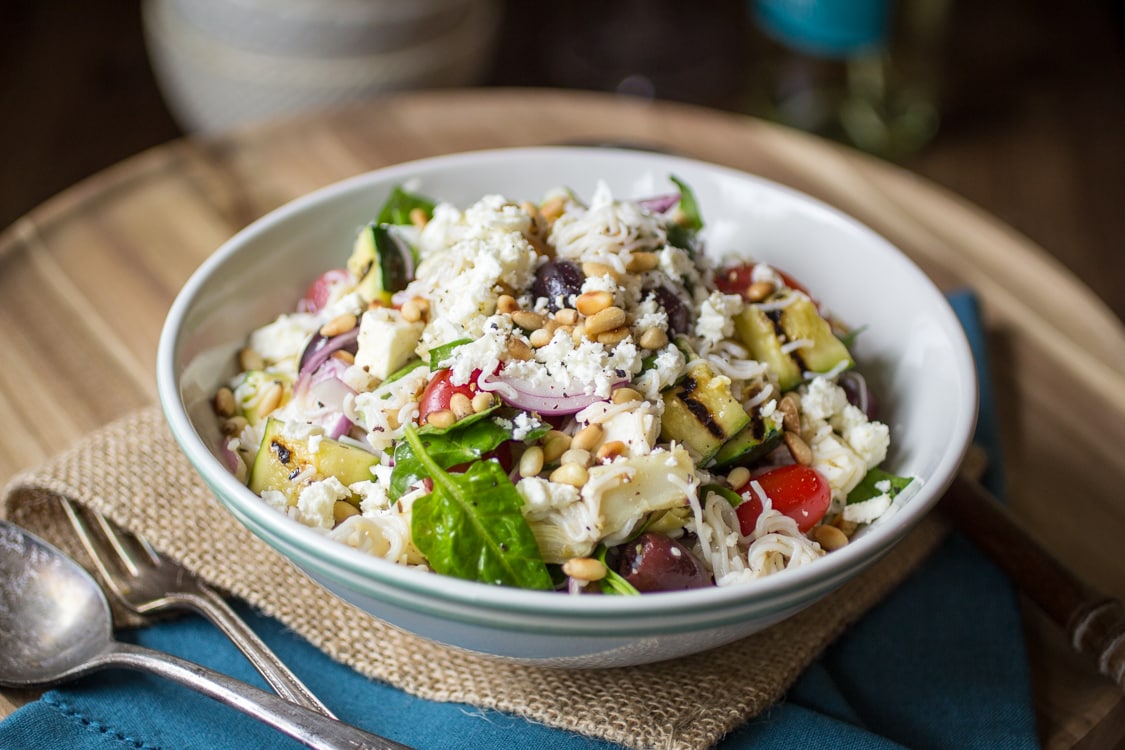 Mediterranean Pasta Salad gets a lightened-up makeover using tofu shirataki noodles. Studded with tomatoes, zucchini, artichokes, and olives, this is one potluck dish that everyone will love!