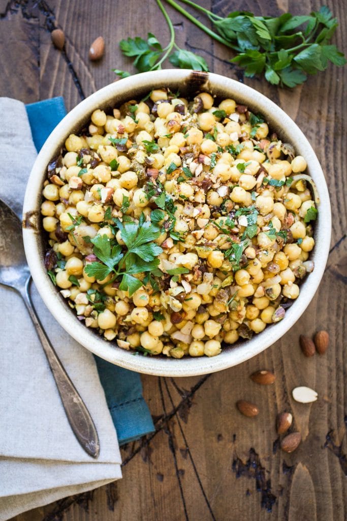 Dried dates and crunchy pistachios make this Moroccan warm chickpea side dish recipe both sweet and savory!