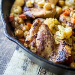 Chickpeas, carrots, and cauliflower add bulk to turn this pan roasted harissa chicken into a one-skillet meal!
