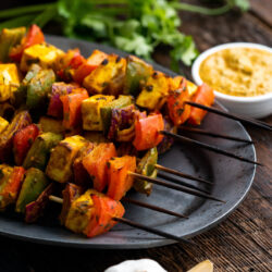 This Paneer Tikka recipe is a scrumptious Indian appetizer loaded with Paneer Cheese and veggies coated in a sauce full of Indian spices!