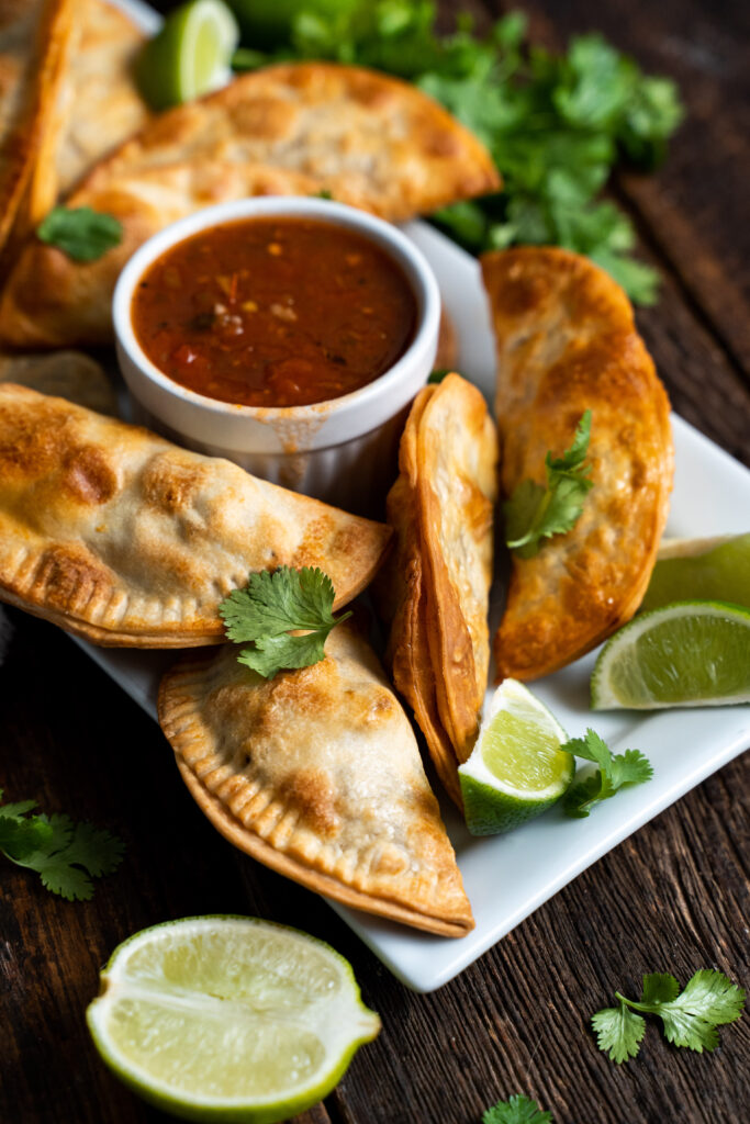 Empanadas Puerto Rican on a white plate with salsa