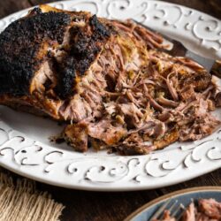 This Puerto Rican Pernil served on a white serving dish.