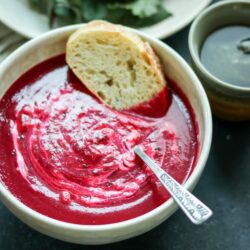 This gorgeous beet soup is so quick and easy - just roast some veggies, simmer with broth, then puree and serve topped with LOTS of sour cream!