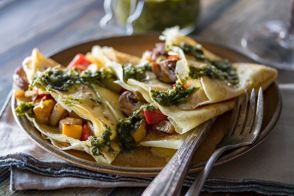 This Savory Crepe recipe mixes mushrooms, potatoes, peppers, squash, and onions as the savory crepe filling with chimichurri sauce over the top for a delicious appetizer or meal.