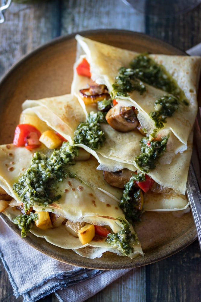 This Savory Crepe recipe mixes mushrooms, potatoes, peppers, squash, and onions as the savory crepe filling with chimichurri sauce over the top for a delicious appetizer or meal.
