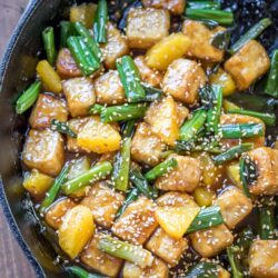 Sesame Orange Tofu - crispy tofu, luscious orange sauce, and bites of fresh orange. Perfection in a pan!