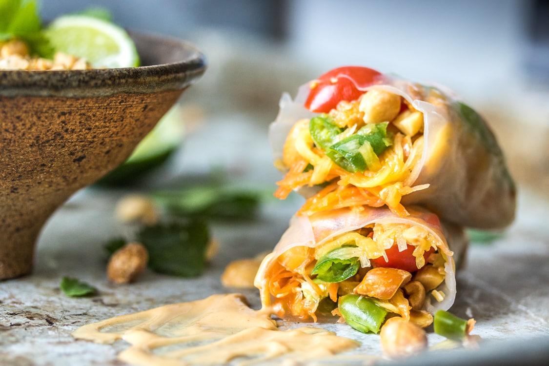 This Thai Style Papaya Salad Rolls recipe wraps up green beans, carrots, tomatoes, green papaya and peanuts with a peanut sauce for a delicious appetizer when you can't decide between fresh rolls and papaya salad!
