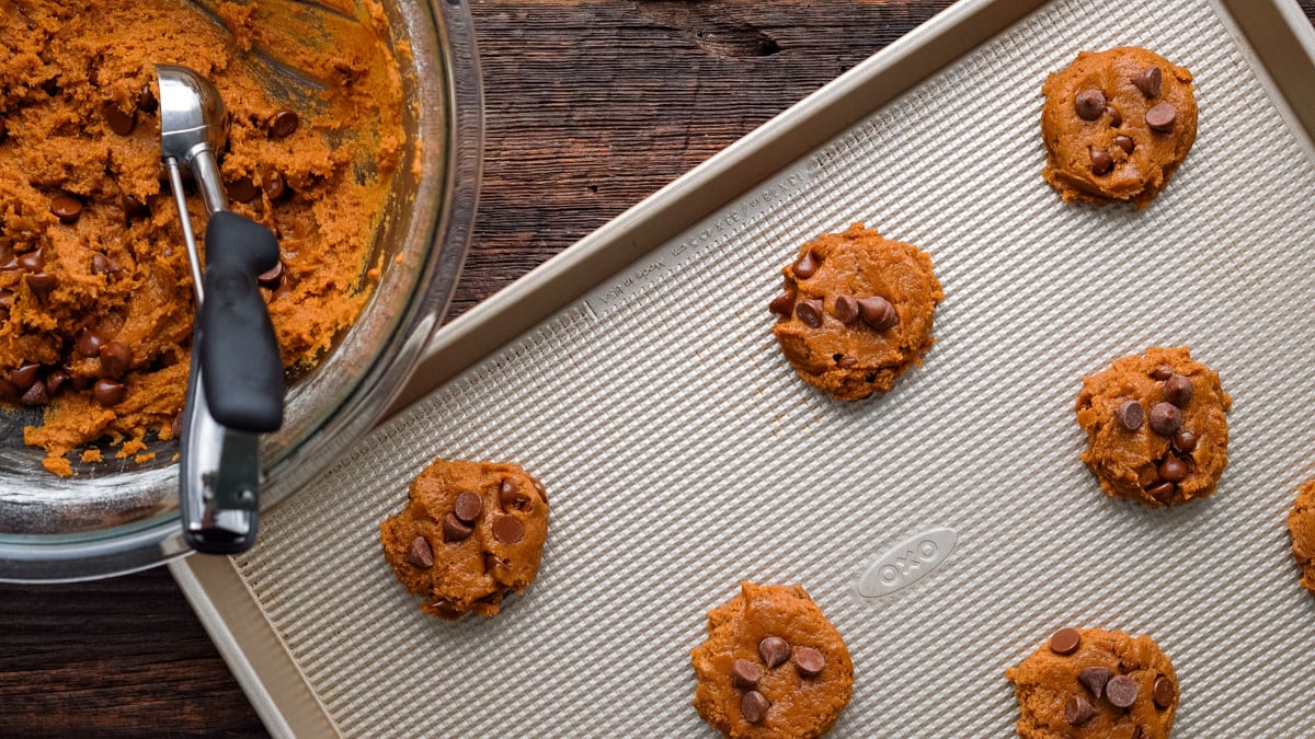 Pumpkin chocolate chip cookies on a baking sheet before baking.